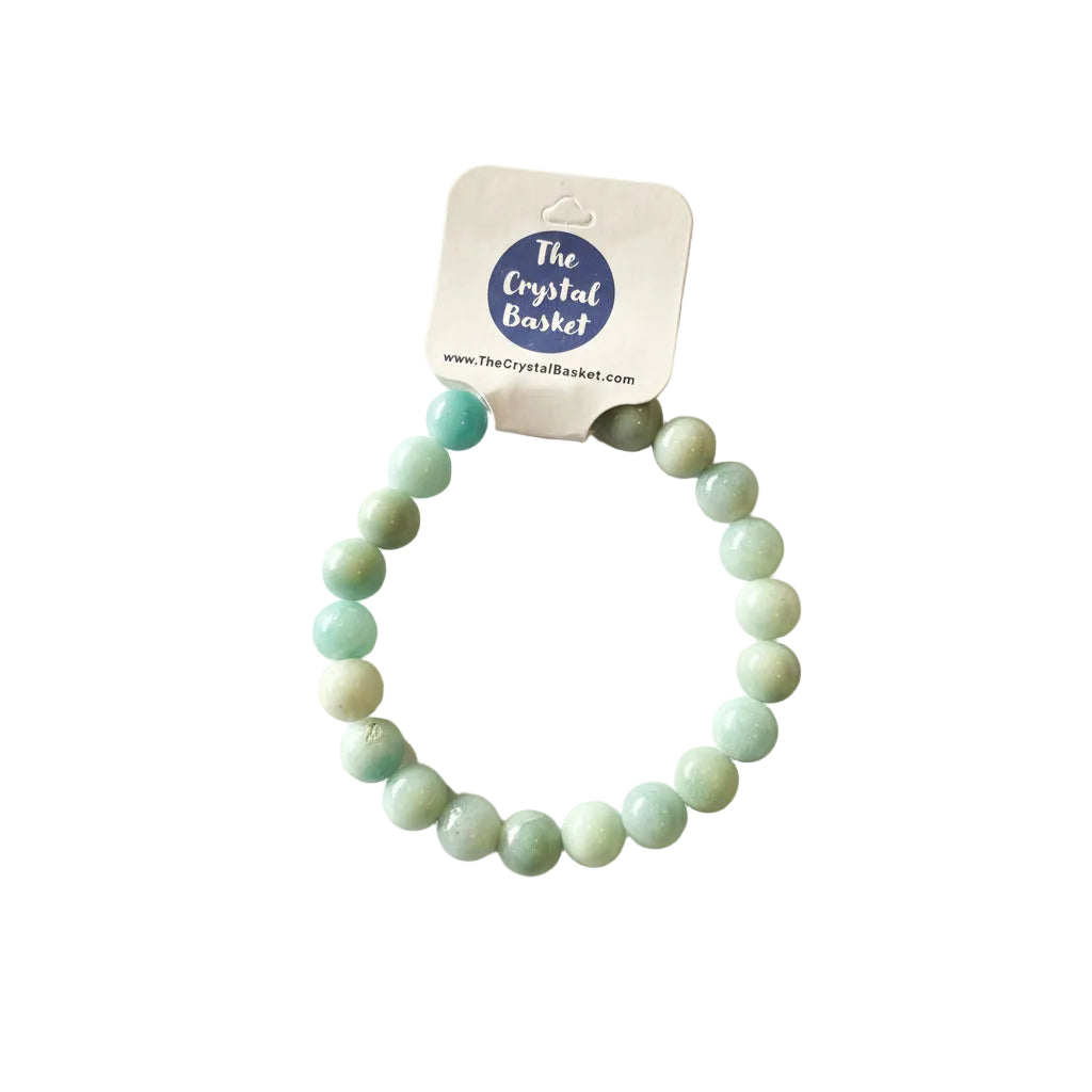 Green beaded bracelet on a gray background with 'The Crystal Basket' label.